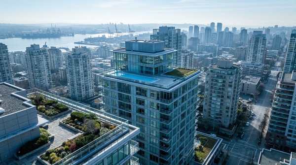 Aerial oblique of penthouse rooftop and surrounding skyline showing urban context and terraces